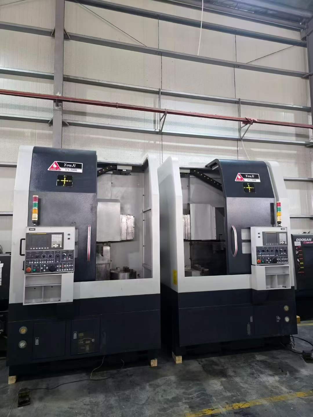 Two Identical You Ji 500 E CNC Vertical Lathes photo 1
