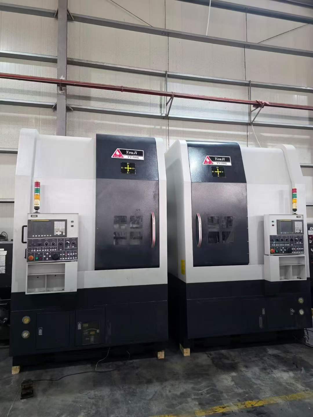 Two Identical You Ji 500 E CNC Vertical Lathes photo 2